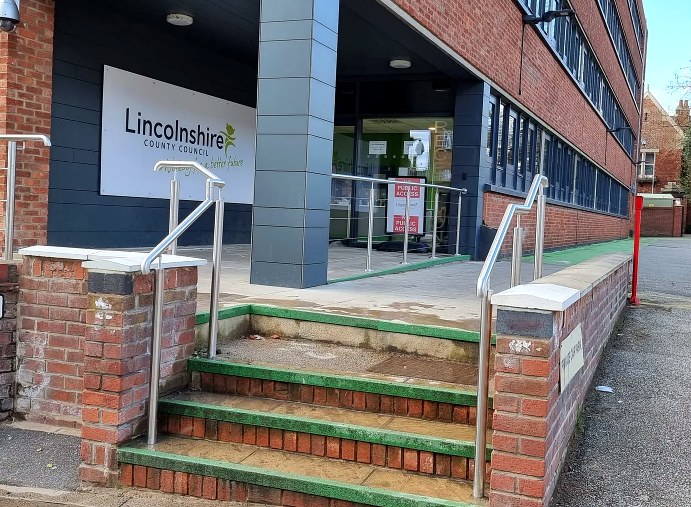 Stainless steel handrails to the entrance steps and accessible ramp at a Lincolnshire County Council building, Lincoln