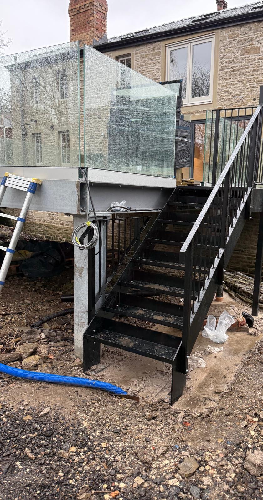 Bespoke steel staircase with balustrade railings and glass panels installed at residential renovation, Barnsley