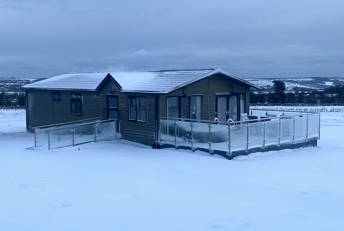 Glass balustrade and accessible ramp to a lodge at Haystax Inclusive Farms in winter, Lanchester