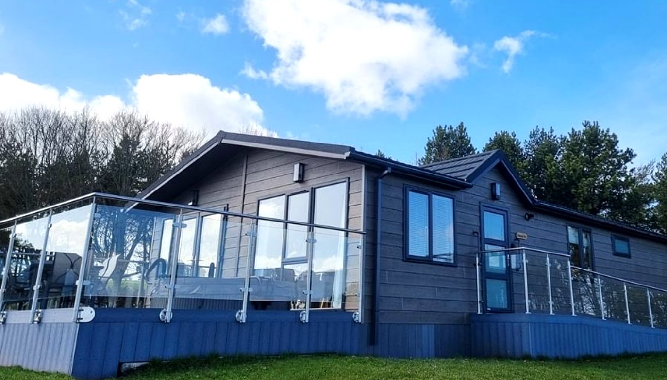 Stainless steel and glass balustrade around the raised lodge decking at Haystax Inclusive Farms, Lanchester