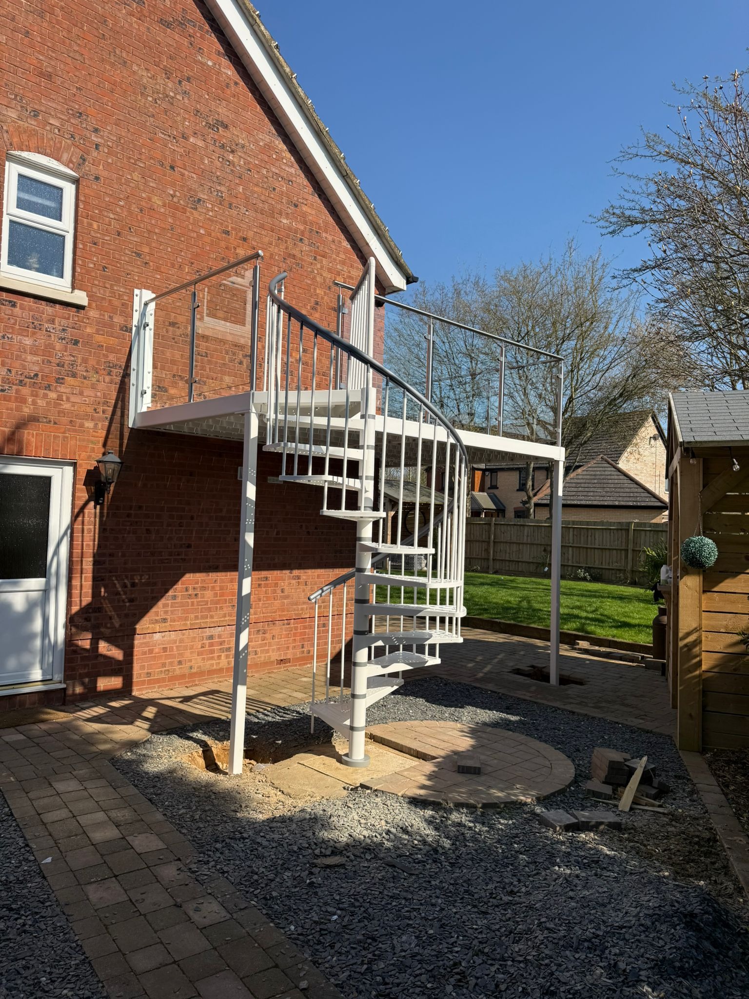 Raised composite decking balcony with stainless steel glass balustrade overlooking lake, Northampton NN4