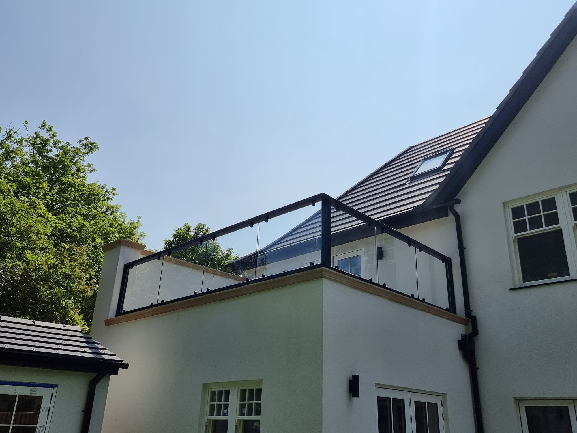 Anthracite grey parapet cavity wall glass balustrade on flat roof terrace, Oxford