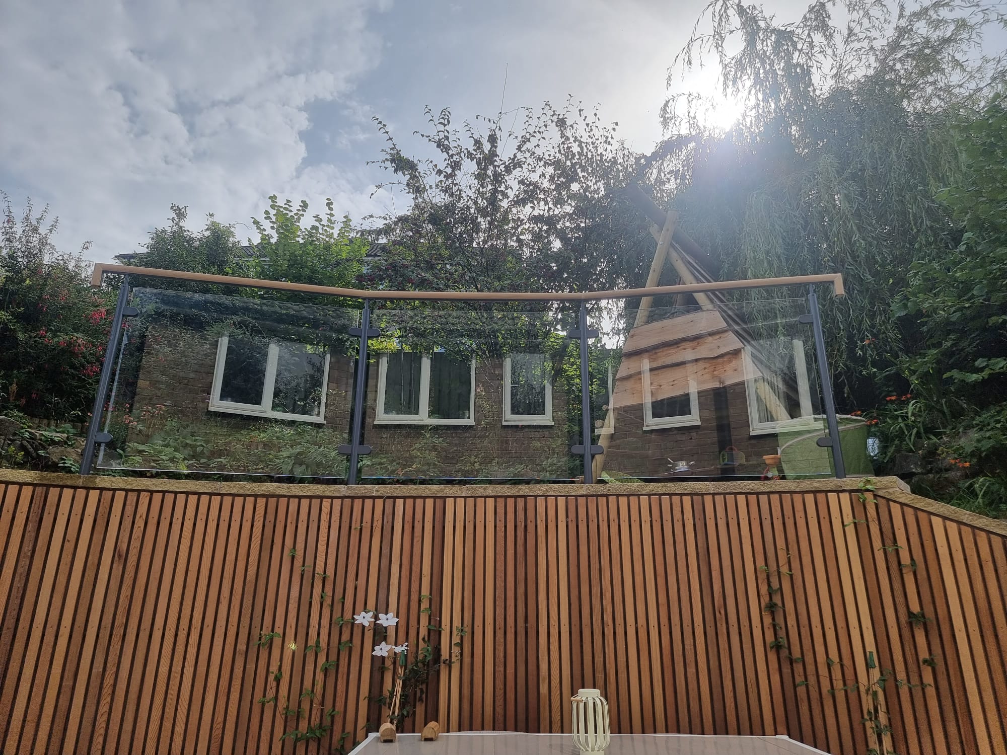 Curved glass balustrade installed to high wall in sheffield