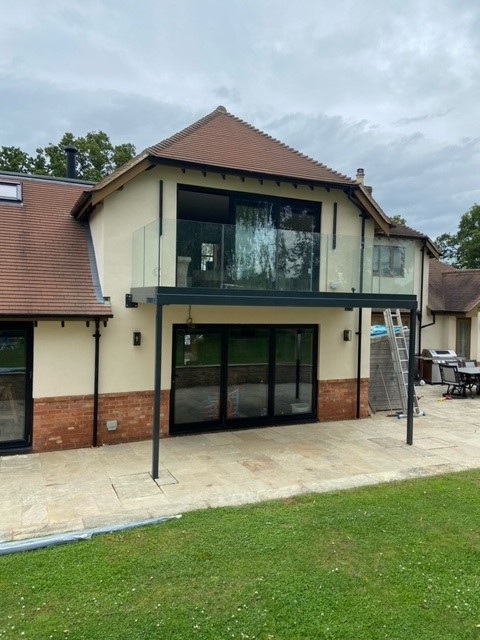 Elevated first floor walkout balcony with frameless balustrade system