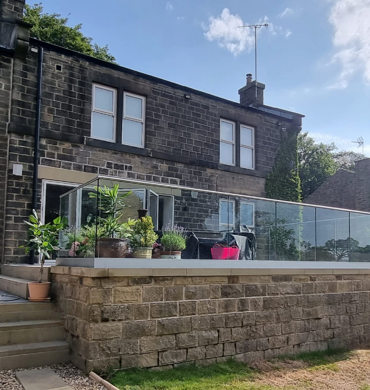 Frameless glass balustrade installed to raised patio in barnsley
