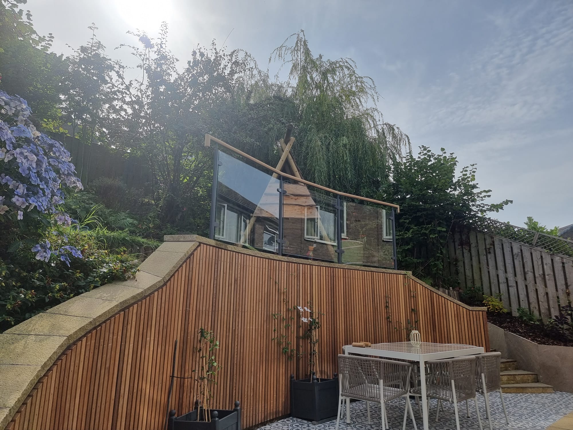 modern glass balustrade with hardwood timber handrail