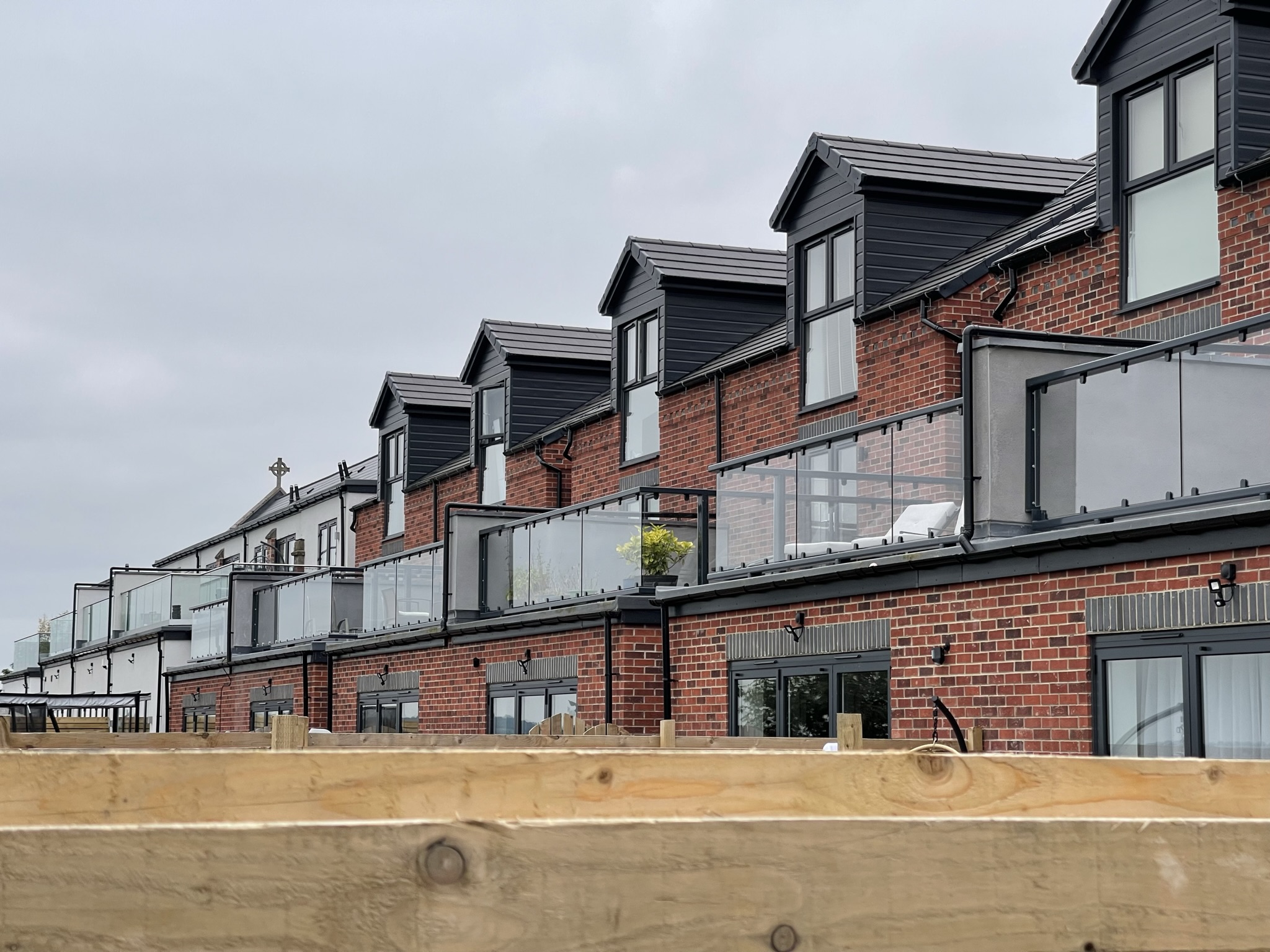 Row of glass balcony balustrades to new builds in chesterfield