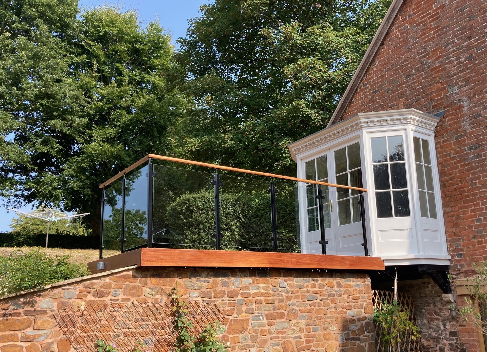 modern glass balustrade with wooden rails