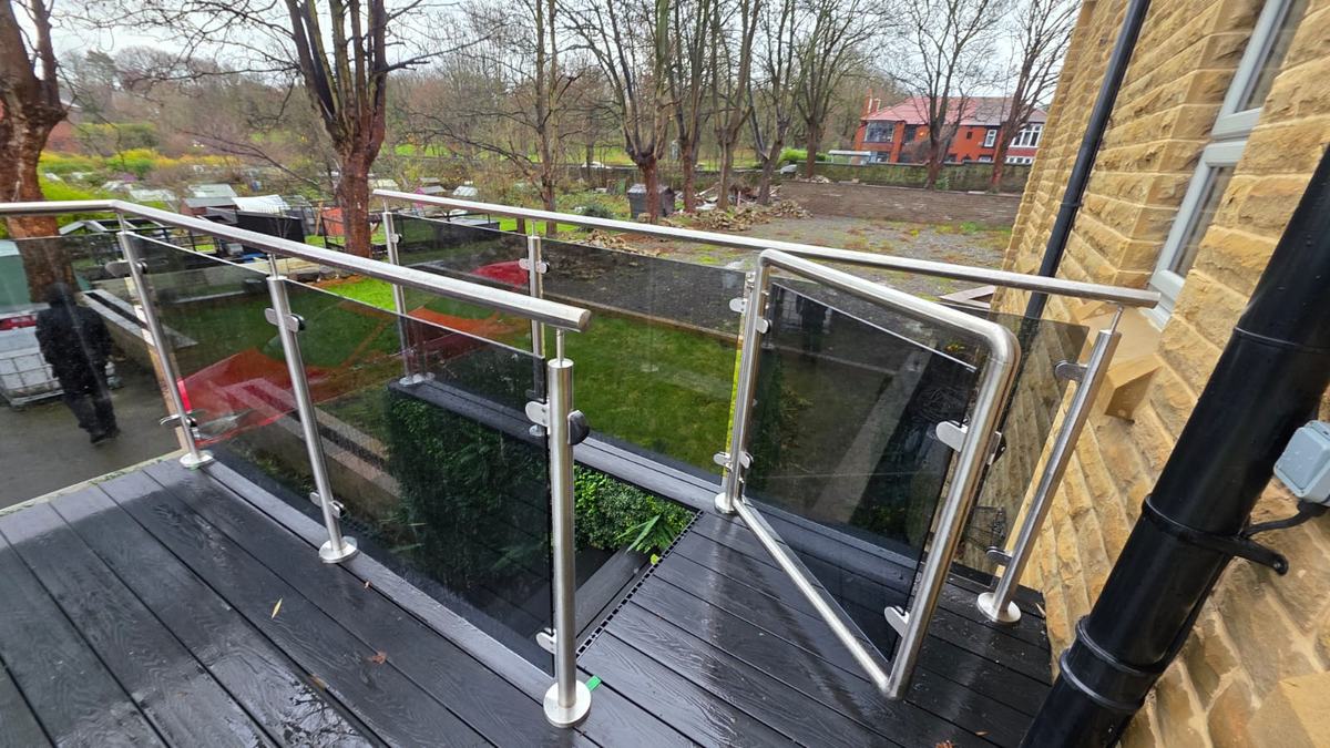 Grey tinted glass balustrade and matching stainless steel glass gate on a raised deck, Barnsley