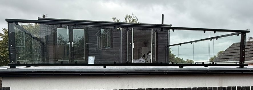 Powder coated glass balustrade to a roof terrace seen from the driveway, Barnsley