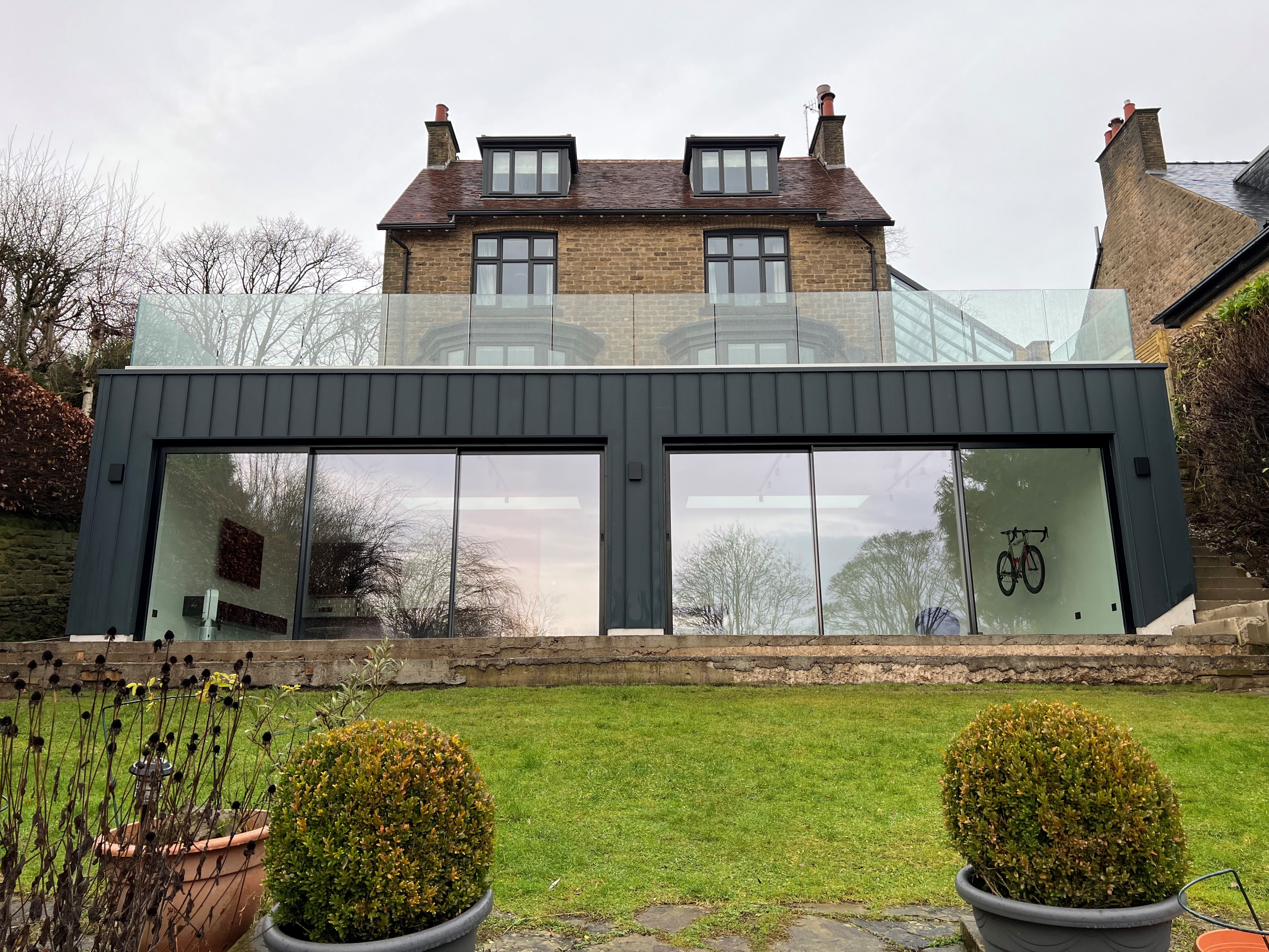 Frameless infinity glass balustrade with no handrails on an elevated extension balcony, Ranmoor, Sheffield