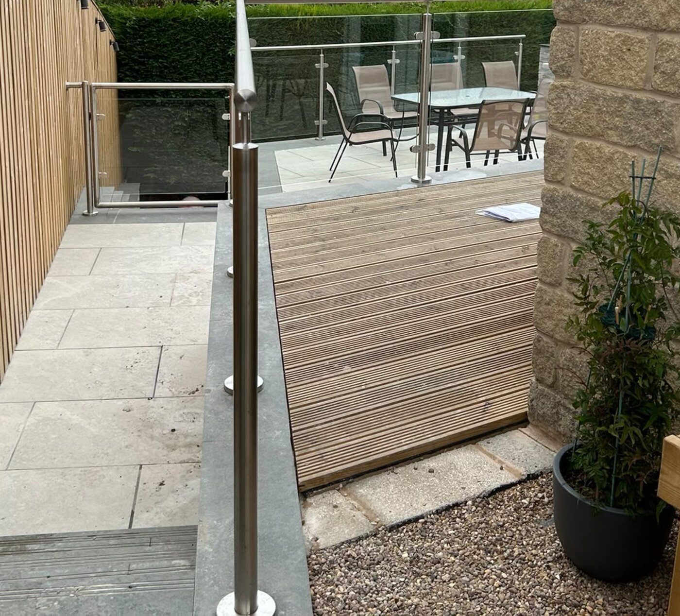 Core drilled stainless steel balustrade post with cover rose on porcelain paving, Rotherham