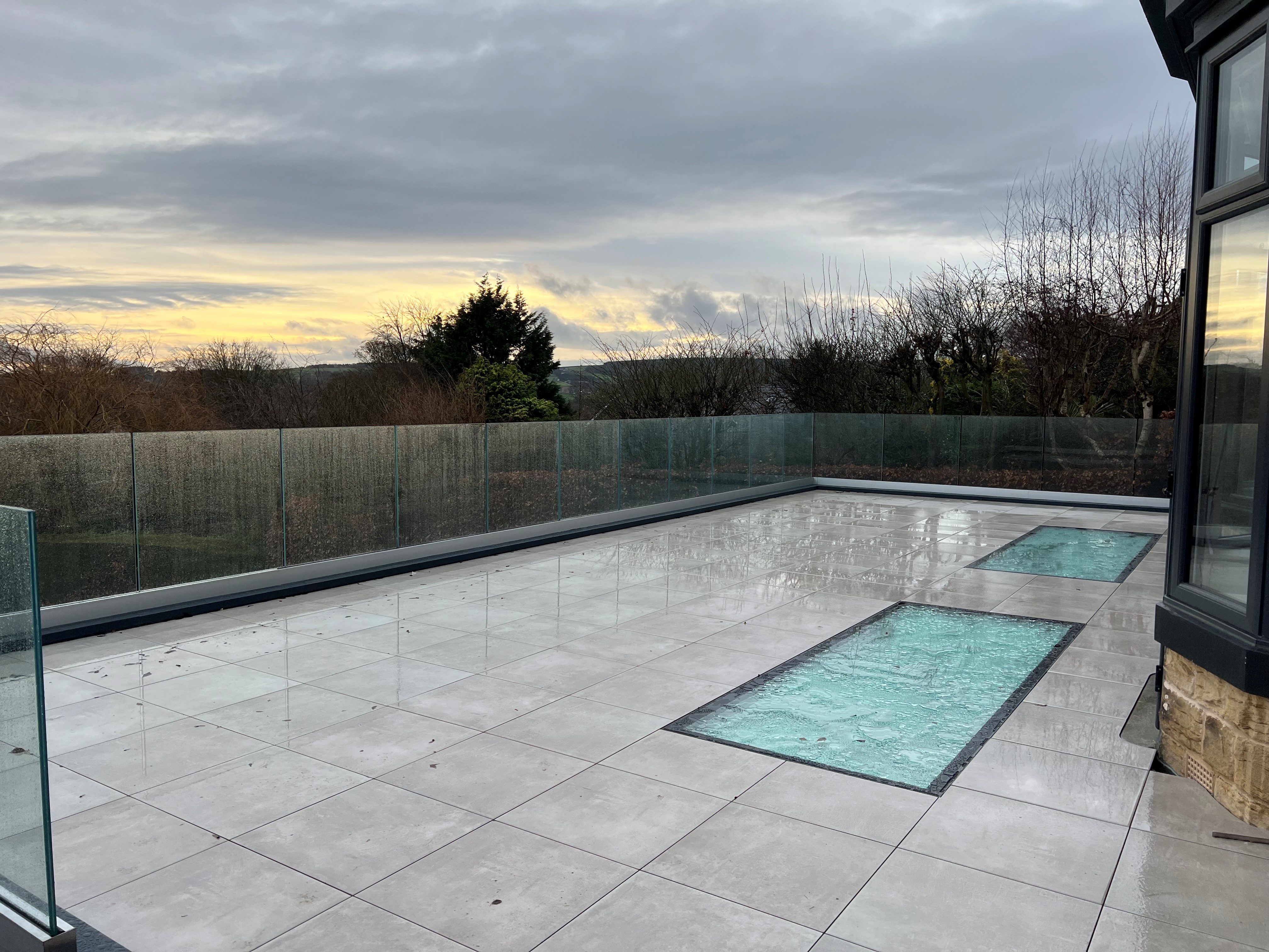 Frameless laminated glass set into a base channel on a new extension balcony, Sheffield