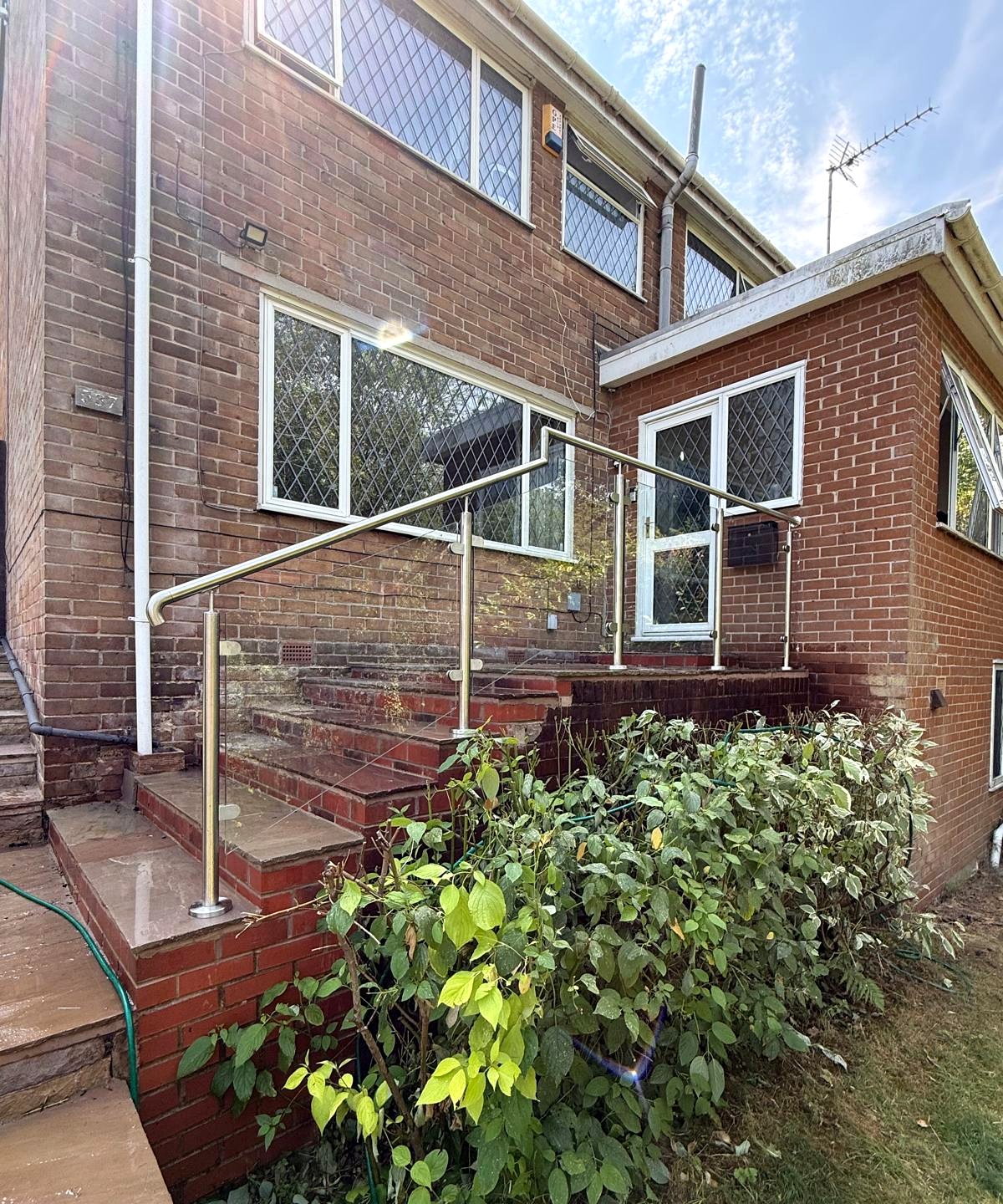 Glass balustrade and stainless handrail guarding external entrance steps in Sheffield