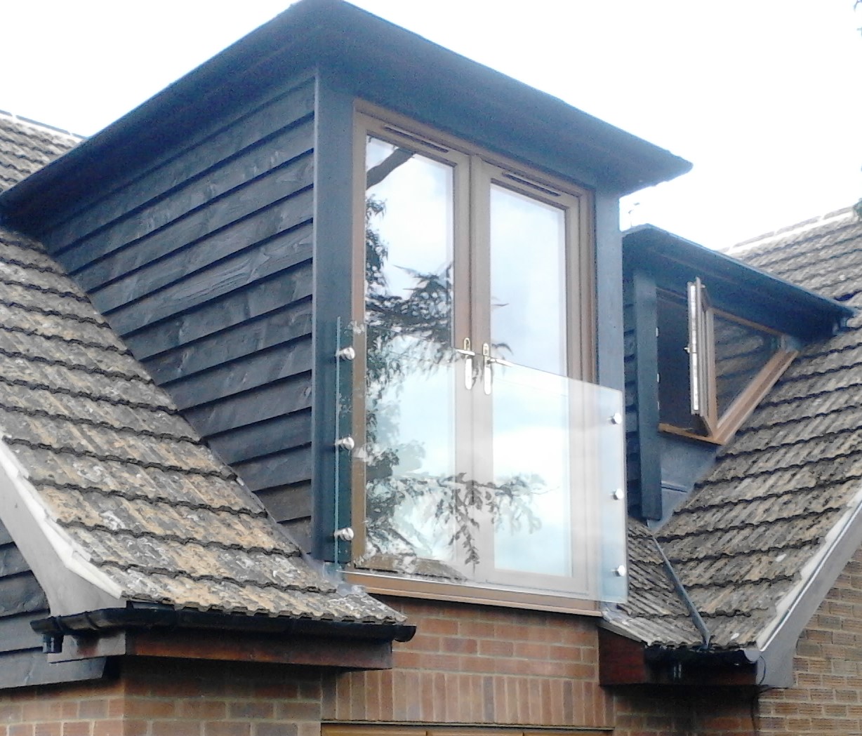 Frameless glass Juliet balcony fitted to a pair of first floor French doors