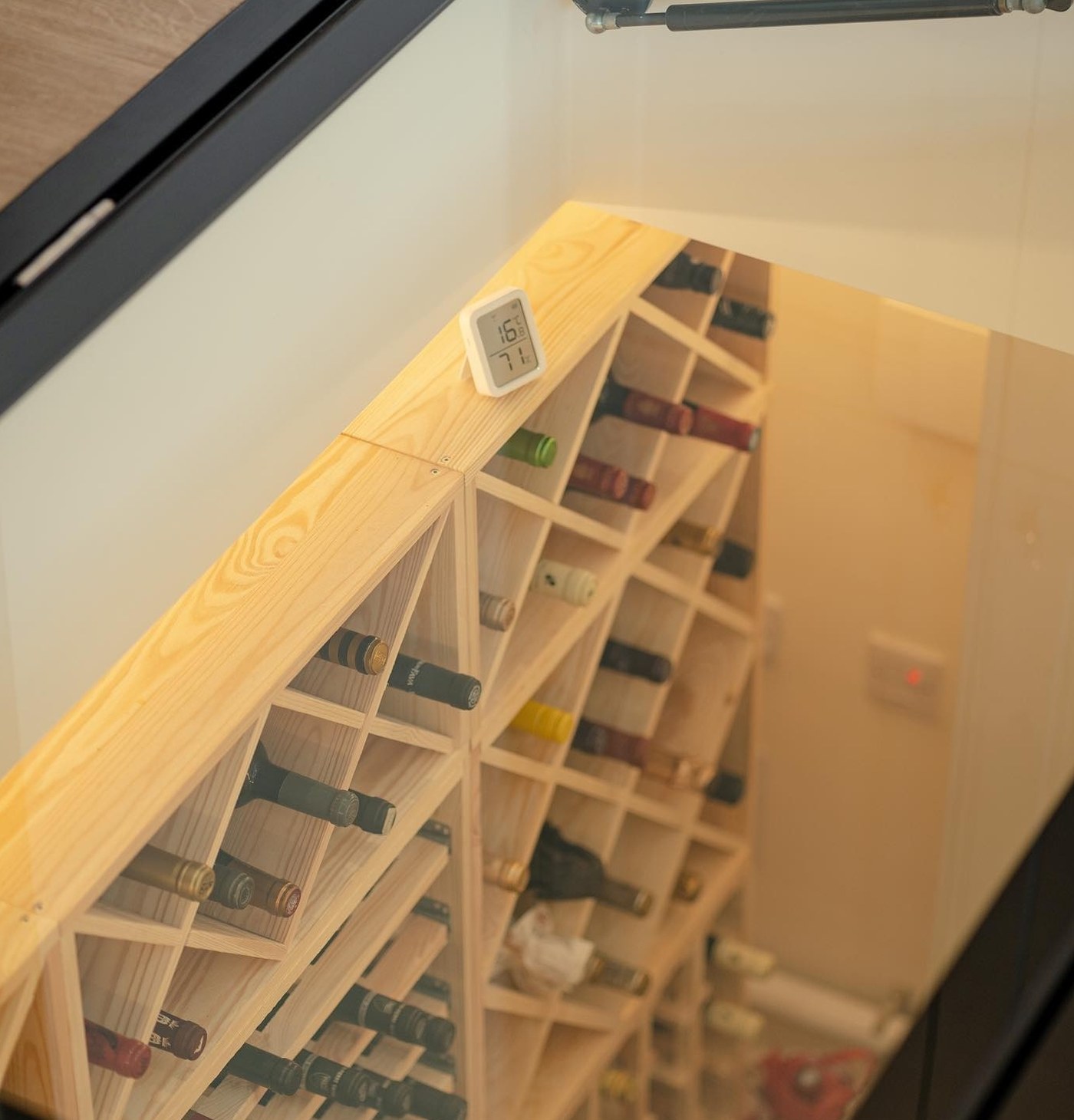 Wine racking in a converted coal store lit from the glass floor hatch above