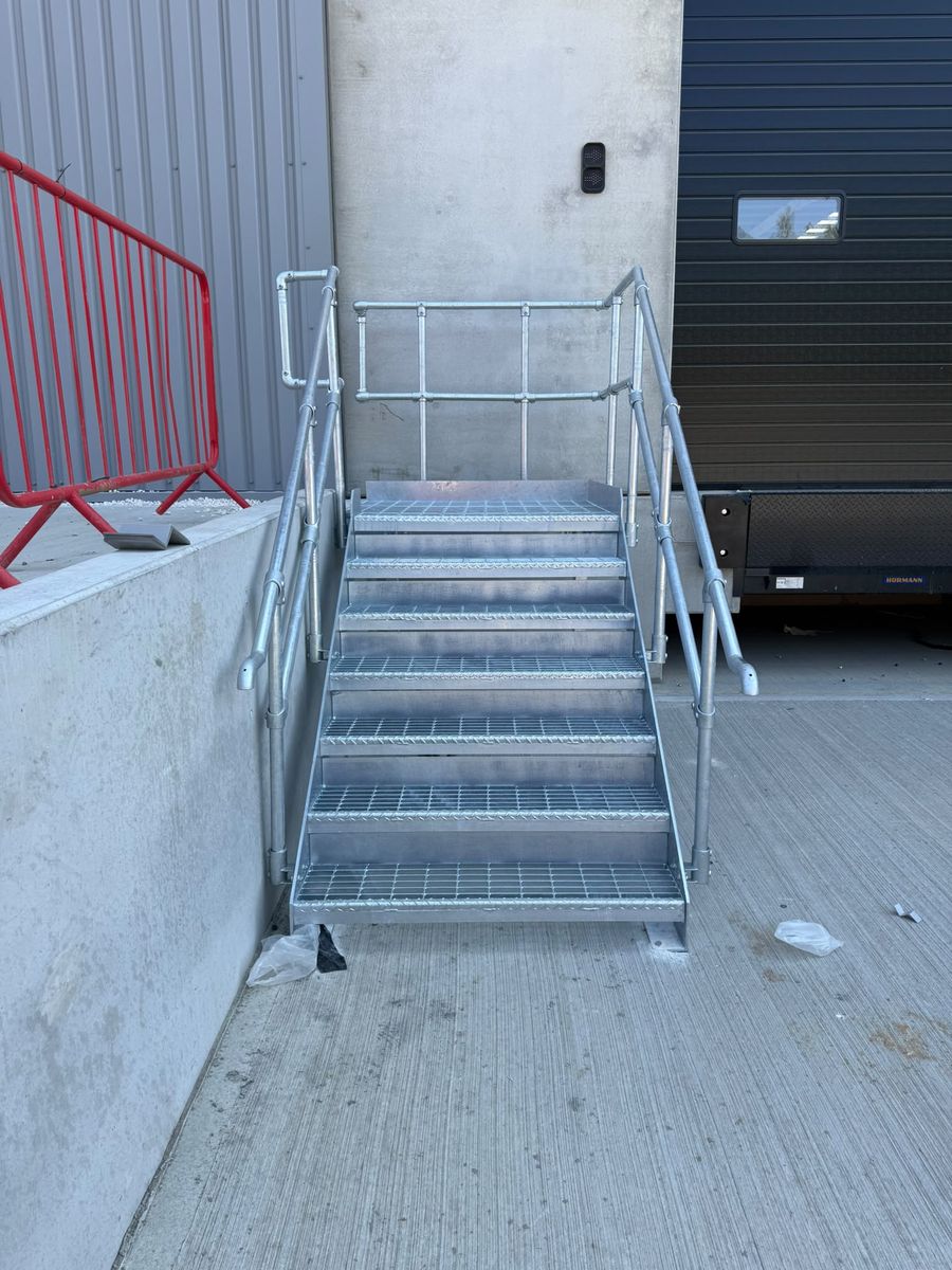 Galvanised loading dock access stairs with open mesh treads and key clamp handrails, Markham Vale Derbyshire
