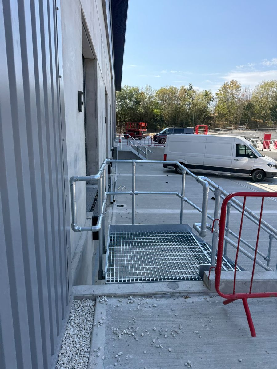 Open mesh crossover platform with key clamp guarding at a loading dock door, Markham Vale Derbyshire