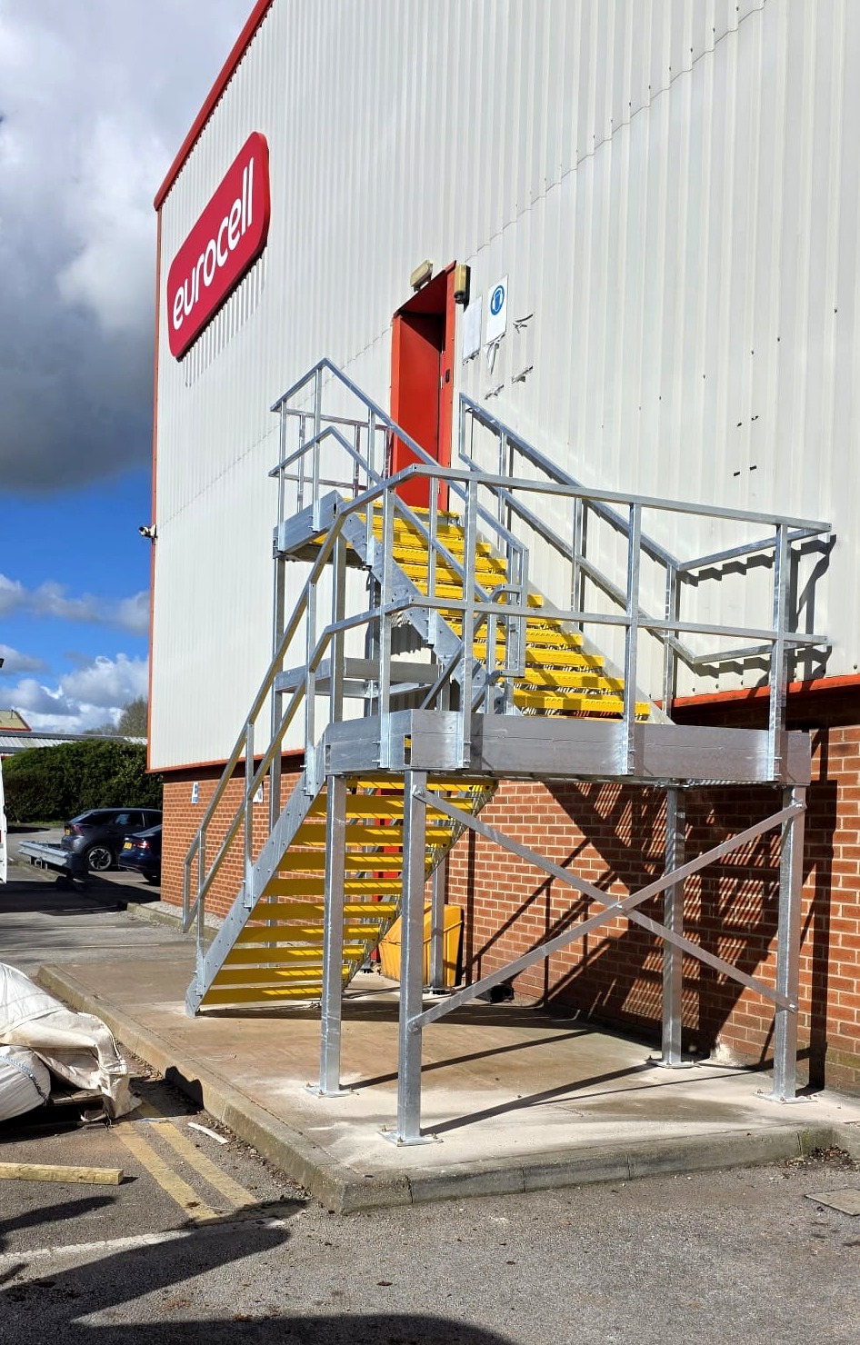 Galvanised fire escape staircase at Eurocell head office Alfreton, front elevation showing top landing and stair flight