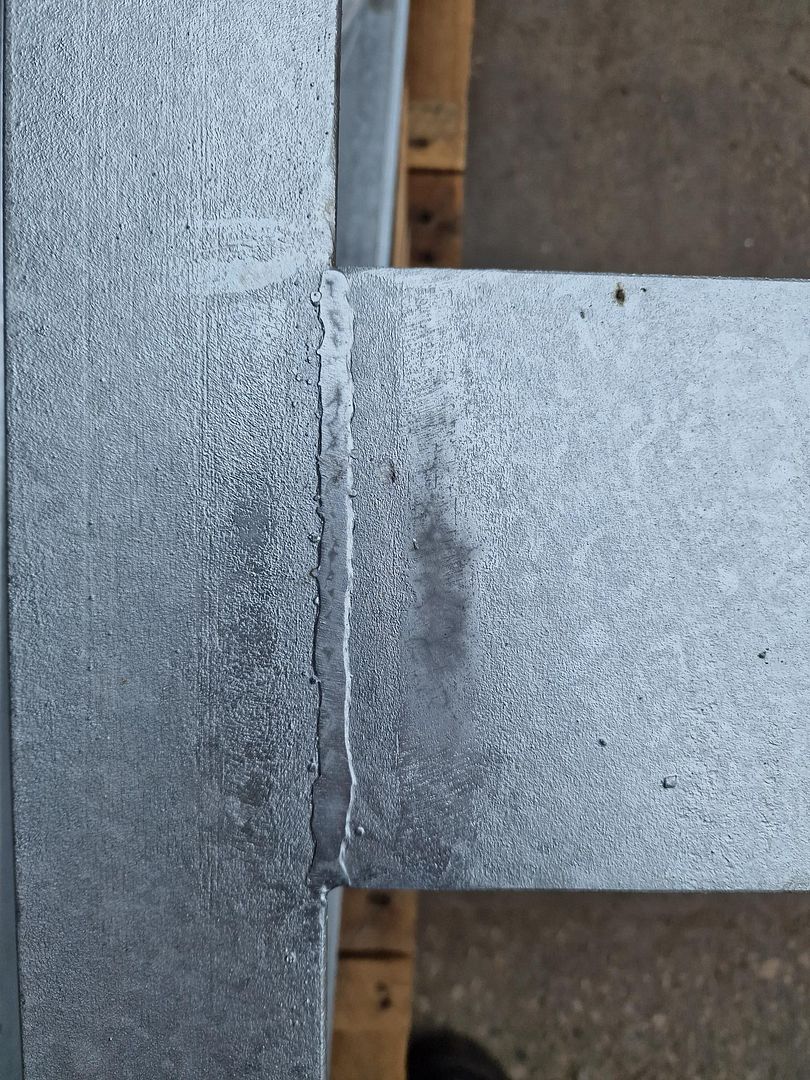 Steel balcony frame being lowered into the molten zinc bath during hot dip galvanizing
