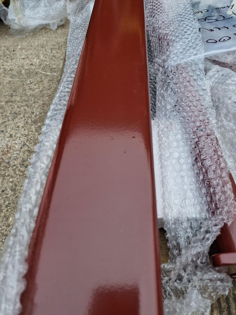 Minor rough patches visible through powder coating over galvanized steel, an expected result of zinc build up