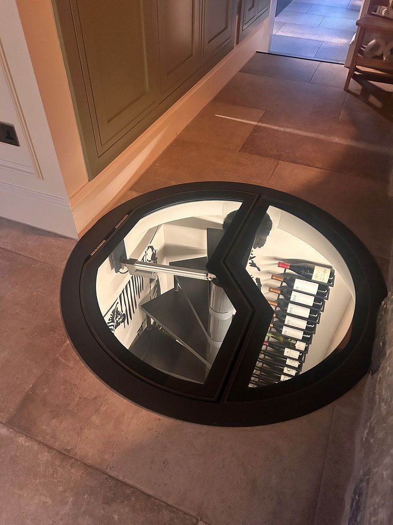 electric wine cellar glass door hatch over spiral staircase