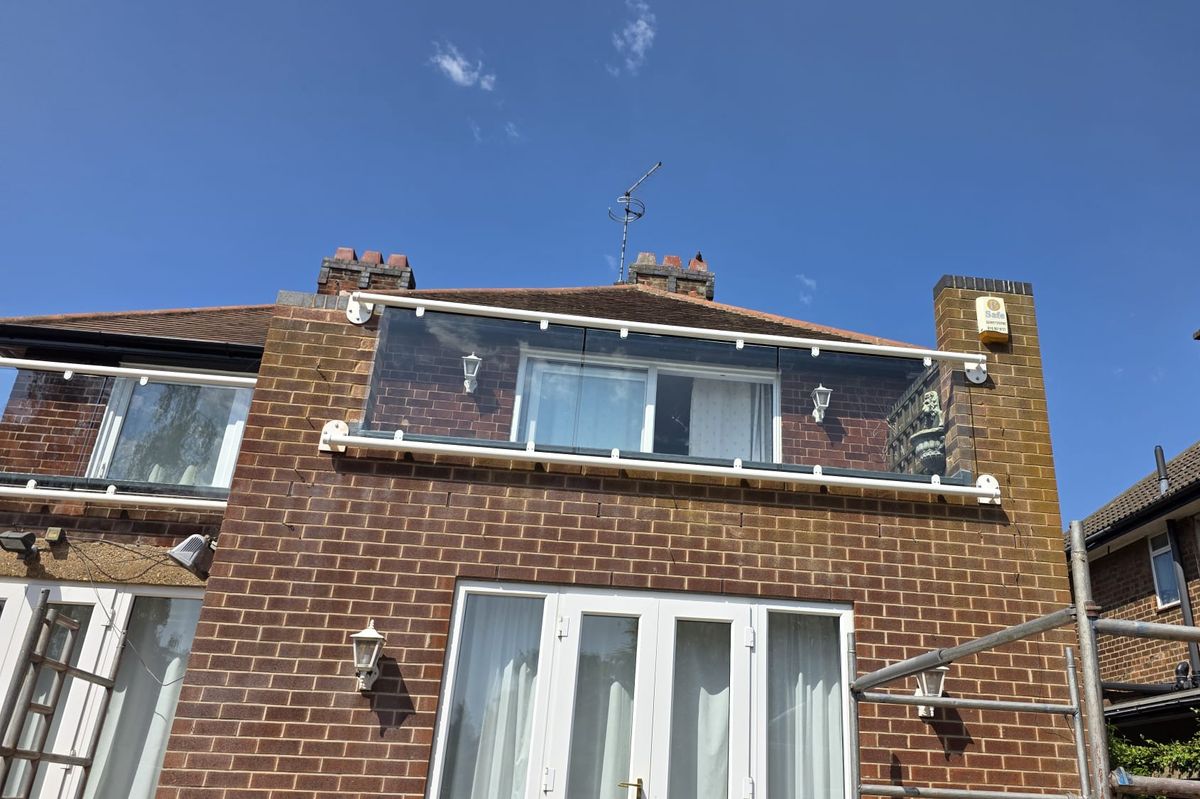Bespoke glass Juliet balcony turning the corner of a flat roof terrace, wall fixed with no posts, Nottingham