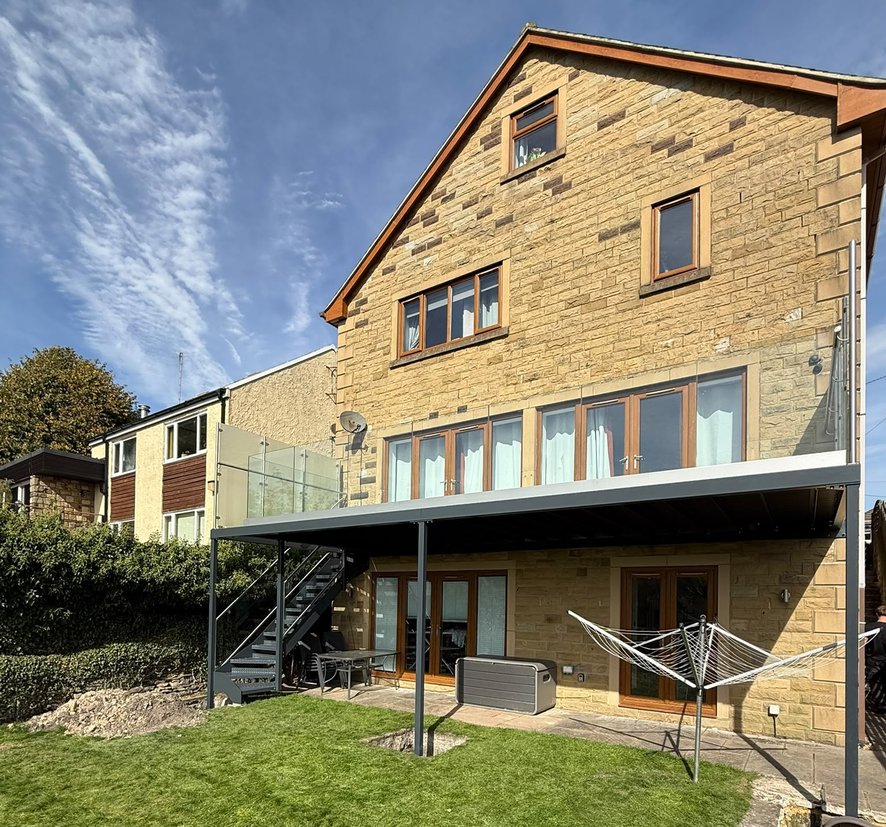 Full rear elevation of the completed walk-out balcony and external staircase in Dronfield