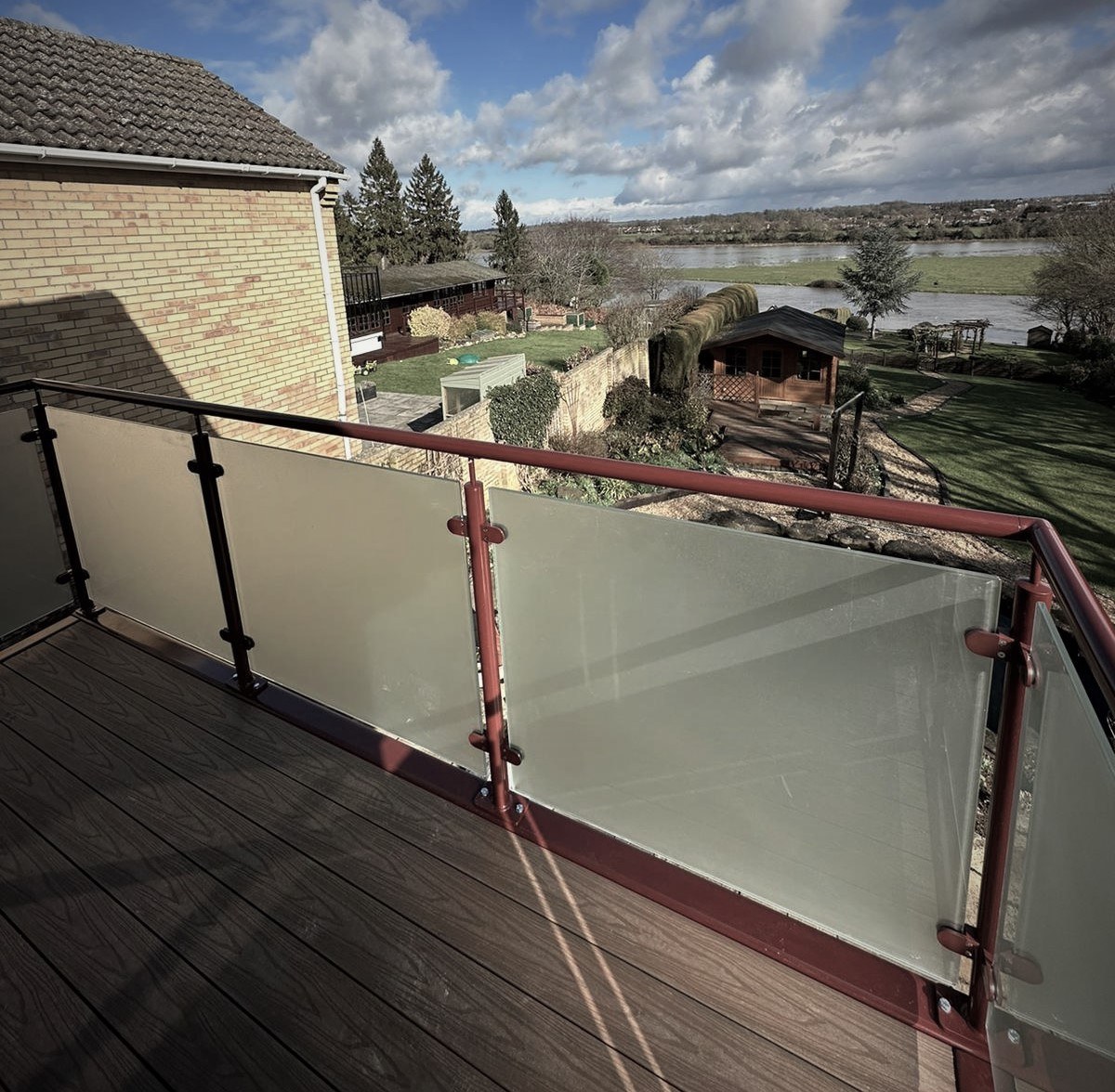 Walkout balcony with obscure glass balustrade looking out over the garden at St Neots, Cambridgeshire