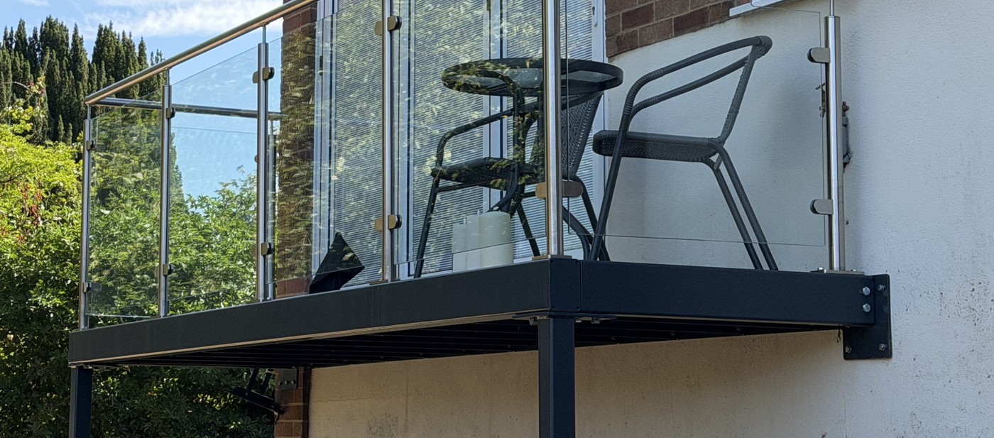 Anthracite grey powder coated steel balcony frame and welded bracket fixed back to the house wall