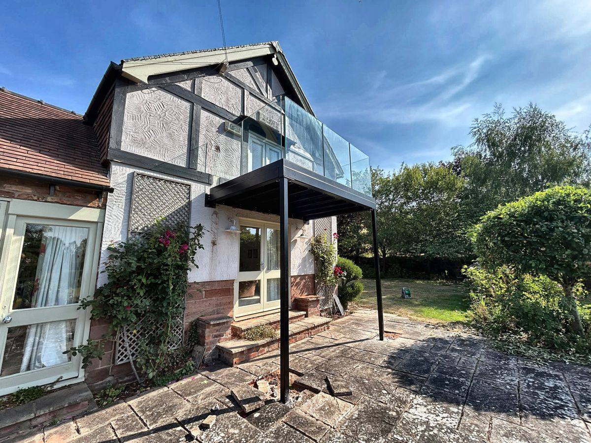 Post-supported steel walkout balcony frame in matt black, Malpas, Cheshire